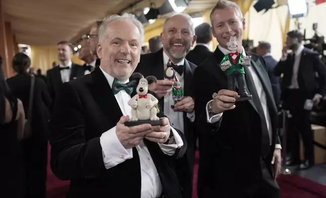 Nick Park, from left, Richard Beek and Merlin Crossingham arrive at the Oscars on Sunday, March 2, 2025, at the Dolby Theatre in Los Angeles. (AP Photo/John Locher)