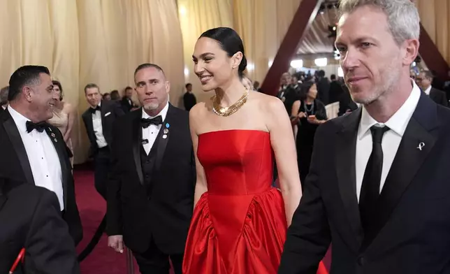 Gal Gadot, left, and Jaron Varsano arrive at the Oscars on Sunday, March 2, 2025, at the Dolby Theatre in Los Angeles. (AP Photo/John Locher)