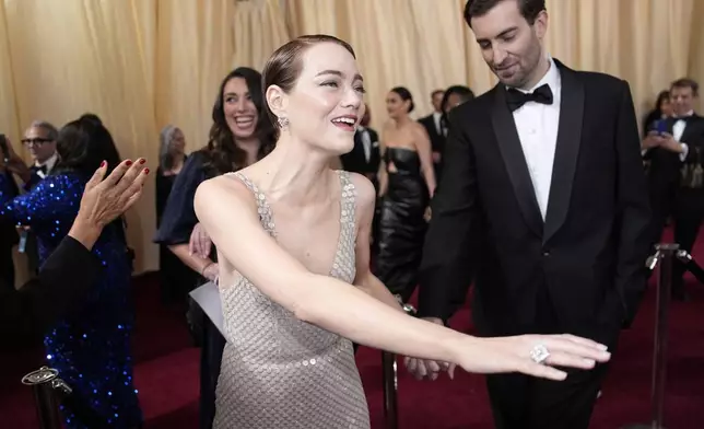 Emma Stone, left, and Dave McCary arrive at the Oscars on Sunday, March 2, 2025, at the Dolby Theatre in Los Angeles. (AP Photo/John Locher)