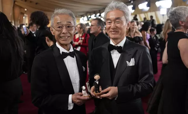 Daisuke Nishio, left, and Takashi Washio arrive at the Oscars on Sunday, March 2, 2025, at the Dolby Theatre in Los Angeles. (AP Photo/John Locher)