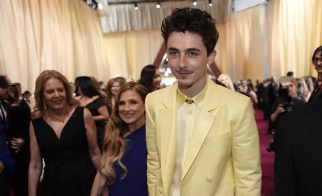 Nicole Flender, left, and Timothée Chalamet arrive at the Oscars on Sunday, March 2, 2025, at the Dolby Theatre in Los Angeles. (AP Photo/John Locher)