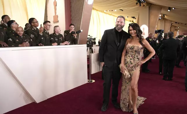Paul Debevec, left, and Tia Carrere arrive at the Oscars on Sunday, March 2, 2025, at the Dolby Theatre in Los Angeles. (AP Photo/John Locher)