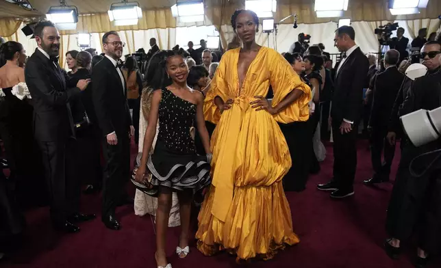 Liyabona Mroqoza, left, and Avumile Qongqo arrive at the Oscars on Sunday, March 2, 2025, at the Dolby Theatre in Los Angeles. (AP Photo/John Locher)
