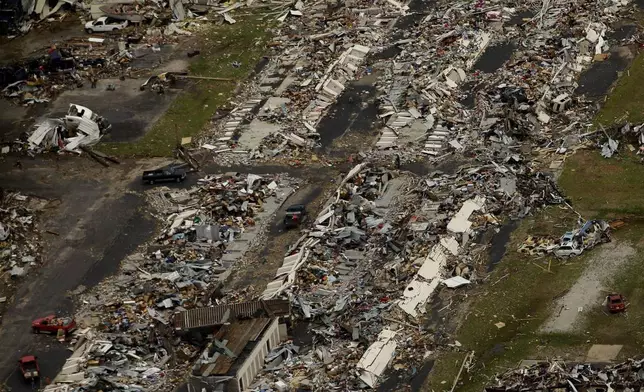 FILE- In this May 24, 2011 file photo, a destroyed neighborhood is seen in Joplin, Mo. (AP Photo/Charlie Riedel, File)