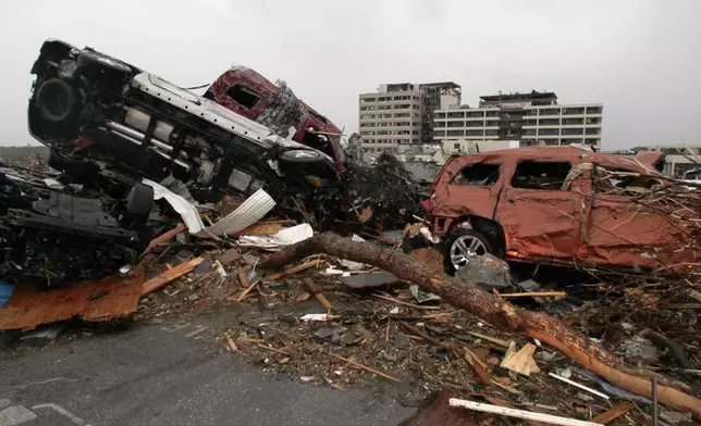FILE- Cars litter the parking lot at the damaged St. John's Regional Medical Center in Joplin, Mo., Monday, May 23, 2011. (AP Photo/Charlie Riedel, File)