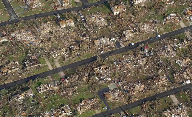 FILE- A destroyed neighborhood is seen in Joplin, Mo. Tuesday, May 24, 2011. (AP Photo/Charlie Riedel, File)