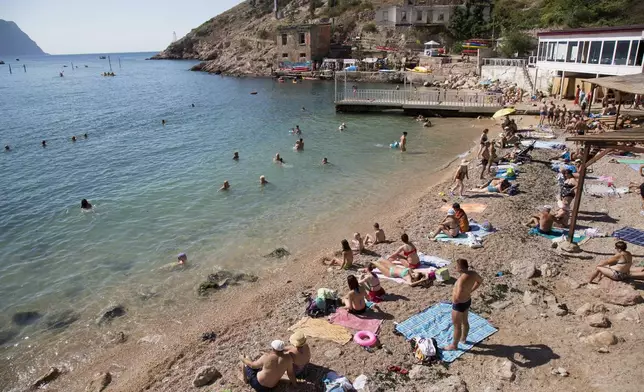 FILE - People gather at a beach in Balaklava Bay, part of Sevastopol on the Crimean Peninsula, Aug. 9, 2015. (AP Photo, File)