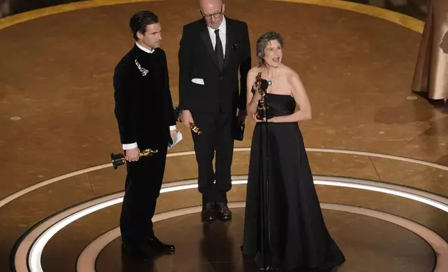 Clement Ducol, from left, Jacques Audiard, and Camille accept the award for best original song for "El Mal" from" Emilia Perez" during the Oscars on Sunday, March 2, 2025, at the Dolby Theatre in Los Angeles. (AP Photo/Chris Pizzello)