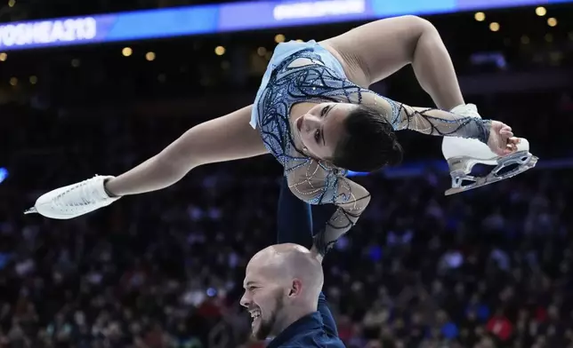 Ellie Kam and Danny O'Shea, of the United States, perform during the pairs free skating program at the figure skating world championships, Thursday, March 27, 2025, in Boston. (AP Photo/Charles Krupa)
