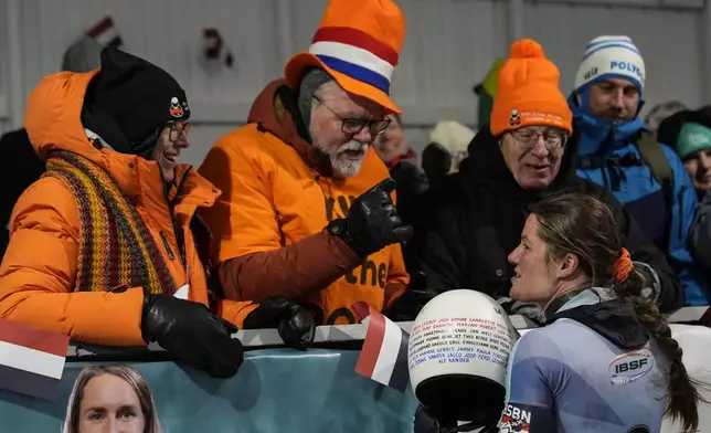 Kimberley Bos, of The Netherlands, speaks to people during fourth run at the skeleton world championships, Friday, March 7, 2025, in Lake Placid, N.Y. (AP Photo/Julia Demaree Nikhinson)