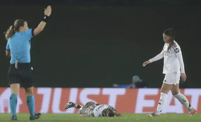 Real Madrid's Melanie Leupolz lies on the ground after getting hurt during the Women's Champions League quarterfinal first leg soccer match between Real Madrid and Arsenal at the Alfredo di Stefano stadium in Madrid, Spain, Tuesday March 18, 2025. (AP Photo/Fran Berg)