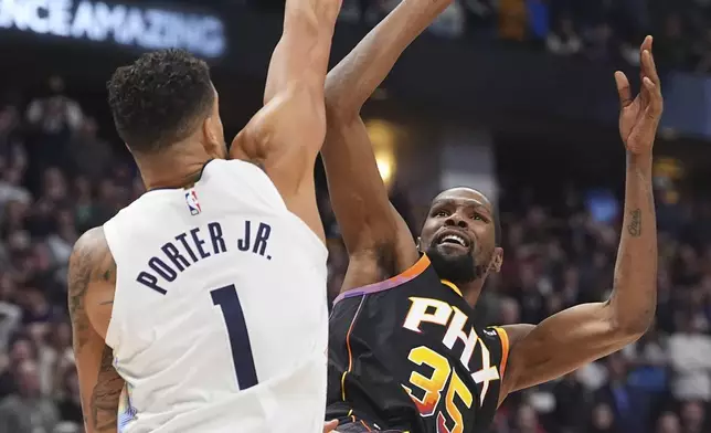 Denver Nuggets forward Michael Porter Jr., left, fouls Phoenix Suns forward Kevin Durant in overtime of an NBA basketball game Friday, March 7, 2025, in Denver. (AP Photo/David Zalubowski)
