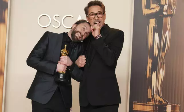 Kieran Culkin, left, winner of the award for best performance by an actor in a supporting role for "A Real Pain," poses with Robert Downey Jr. in the press room at the Oscars on Sunday, March 2, 2025, at the Dolby Theatre in Los Angeles. (Photo by Jordan Strauss/Invision/AP)