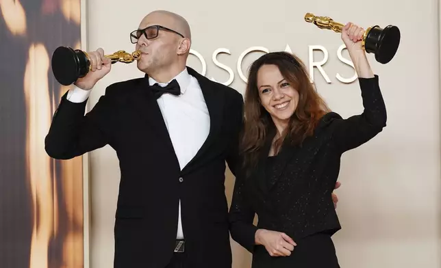 Shirin Sohani, left, and Hossein Molayemi, winners of the award for best animated short for "In the Shadow of the Cypress," pose in the press room at the Oscars on Sunday, March 2, 2025, at the Dolby Theatre in Los Angeles. (Photo by Jordan Strauss/Invision/AP)