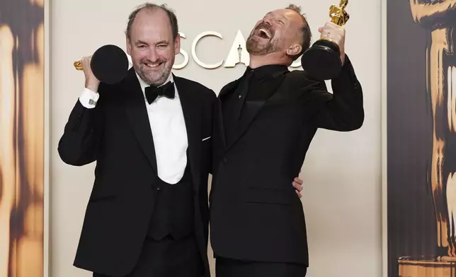 Nathan Crowley, left, and Lee Sandales, winners of the award for best production design for "Wicked," pose in the press room at the Oscars on Sunday, March 2, 2025, at the Dolby Theatre in Los Angeles. (Photo by Jordan Strauss/Invision/AP)
