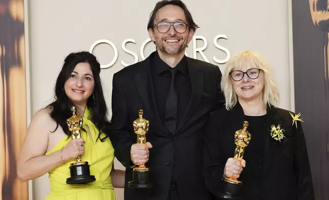 Marilyne Scarselli, from left, Pierre-Olivier Persin, and Stephanie Guillon, winners of the award for best makeup and hairstyling for "The Substance," pose in the press room at the Oscars on Sunday, March 2, 2025, at the Dolby Theatre in Los Angeles. (Photo by Jordan Strauss/Invision/AP)