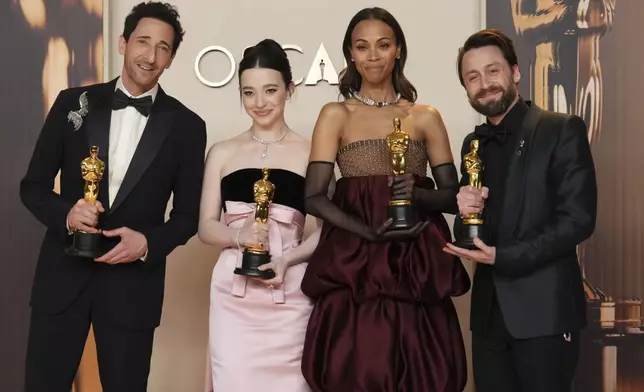 Adrien Brody, from left, winner of the award for best performance by an actor in a leading role for "The Brutalist," Mikey Madison, winner of the award for best performance by an actress in a leading role for "Anora," Zoe Saldana, winner of the award for best performance by an actress in a supporting role for "Emilia Perez," and Kieran Culkin, winner of the award for best performance by an actor in a supporting role for "A Real Pain," pose in the press room at the Oscars on Sunday, March 2, 2025, at the Dolby Theatre in Los Angeles. (Photo by Jordan Strauss/Invision/AP)