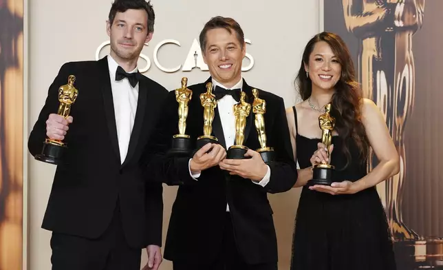 Alex Coco, from left, winner of the award for best picture for "Anora," Sean Baker, winner of the awards for best original screenplay, best film editing, best director, and best picture for "Anora," and Samantha Quan, winner of the award for best picture for "Anora," pose in the press room at the Oscars on Sunday, March 2, 2025, at the Dolby Theatre in Los Angeles. (Photo by Jordan Strauss/Invision/AP)