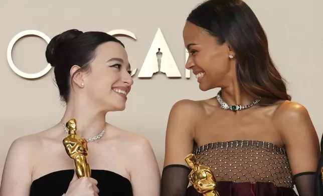 Mikey Madison, left, winner of the award for best performance by an actress in a leading role for "Anora," and Zoe Saldana, winner of the award for best performance by an actress in a supporting role for "Emilia Perez," pose in the press room at the Oscars on Sunday, March 2, 2025, at the Dolby Theatre in Los Angeles. (Photo by Jordan Strauss/Invision/AP)
