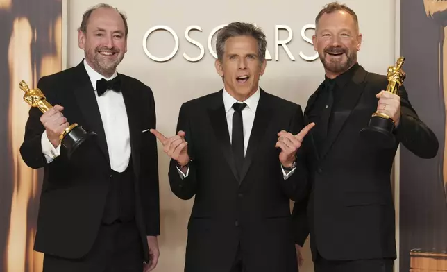 Nathan Crowley, left, and Lee Sandales, right, winners of the award for best production design for "Wicked," pose with Ben Stiller in the press room at the Oscars on Sunday, March 2, 2025, at the Dolby Theatre in Los Angeles. (Photo by Jordan Strauss/Invision/AP)