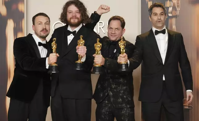 From left, Gints Zilbalodis, Matiss Kaza, Ron Dyens and Gregory Zalcman, winners of the award for best animated feature film for "Flow," pose in the press room at the Oscars on Sunday, March 2, 2025, at the Dolby Theatre in Los Angeles. (Photo by Jordan Strauss/Invision/AP)