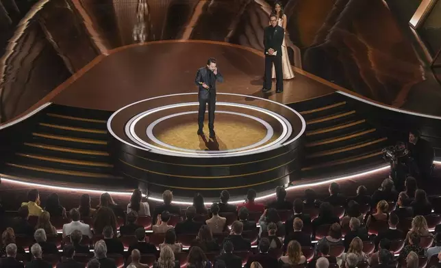 Kieran Culkin accepts the award for best performance by an actor in a supporting role for "A Real Pain" during the Oscars on Sunday, March 2, 2025, at the Dolby Theatre in Los Angeles. Robert Downey Jr. looks on from right.(AP Photo/Chris Pizzello)