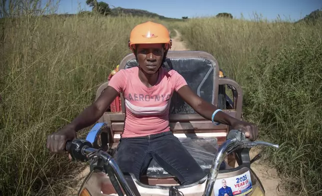 Anna Bhobho delivers tomatoes to a market place on her electric tricycle in Hwedza, Zimbabwe, Thursday, March 6 2025. (AP Photo/Aaron Ufumeli)