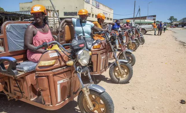 Women sit on their three wheeler tri-cycles waiting for clients at a market place in Hwedza, Zimbabwe, Thursday, March 6, 2025. (AP Photo/Aaron Ufumeli)