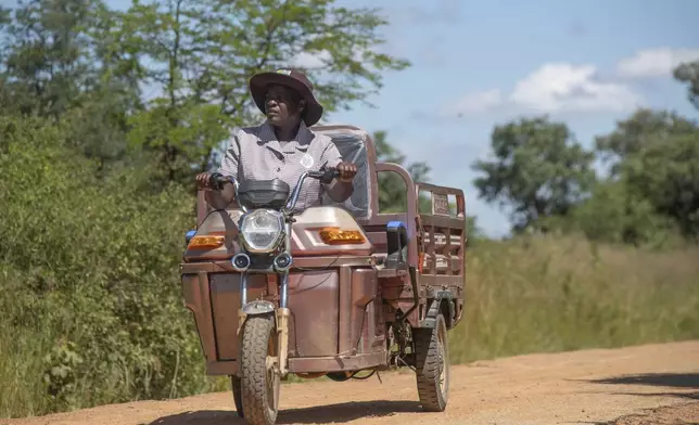 Josephine Nyevhe, a volunteer village health worker, conducts weekly visits on her electric tricycle in Hwedza Zimbabwe, Thursday, March 6 2025. (AP Photo/Aaron Ufumeli)