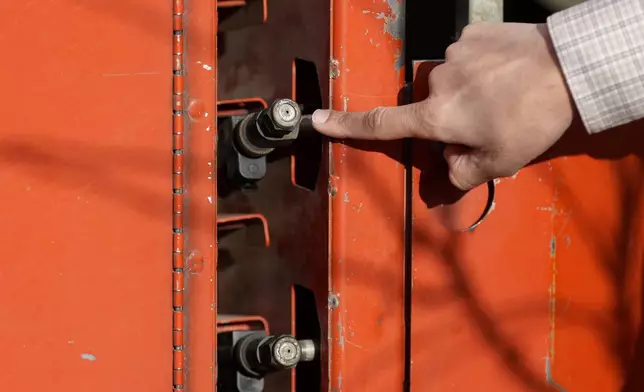 Tyler Klick, Partner/Viticulturist of Redwood Empire Vineyard Management, points toward a spray nozzle on a tank during an interview on AI technology used in the wine industry in Geyserville, Calif., Friday, Jan. 24, 2025. (AP Photo/Jeff Chiu)