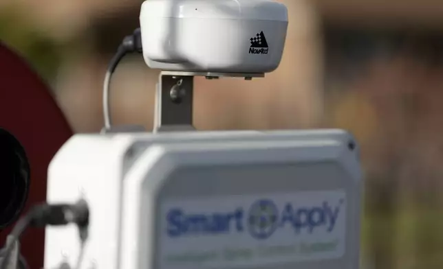 A NovAtel LiDAR device is shown above a Smart Apply Intelligent Spray Control System as Tyler Klick, Partner/Viticulturist of Redwood Empire Vineyard Management, during an interview on AI technology used in the wine industry in Geyserville, Calif., Friday, Jan. 24, 2025. (AP Photo/Jeff Chiu)