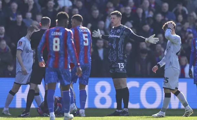 Millwall goalkeeper Liam Roberts reacts before getting a red card for a challenge of Crystal Palace's Jean-Philippe Mateta during the English FA Cup soccer match between Crystal Palace and Millwall at Selhurst Park, London, England, Saturday, March 1, 2025. (AP Photo/Ian Walton)