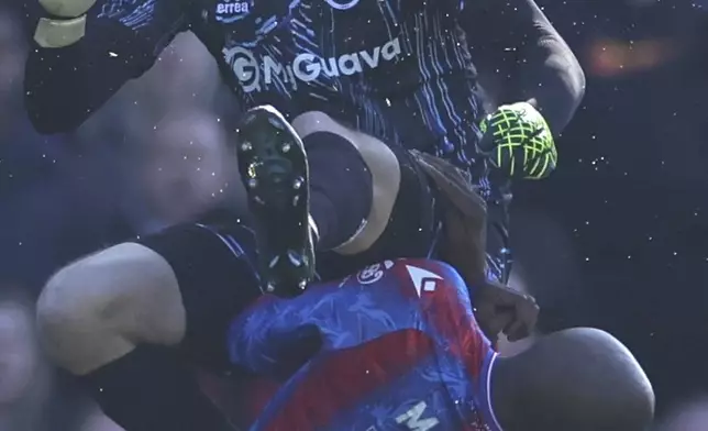 Crystal Palace's Jean-Philippe Mateta is fouled by Millwall goalkeeper Liam Roberts, for which he got a red card, during the English FA Cup soccer match between Crystal Palace and Millwall at Selhurst Park, London, England, Saturday, March 1, 2025. (AP Photo/Ian Walton)