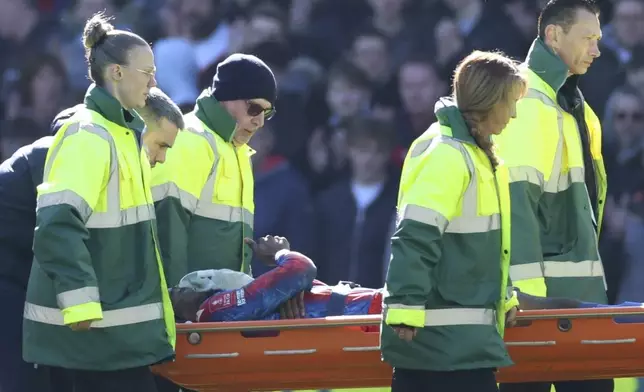 Crystal Palace's Jean-Philippe Mateta is taken off on a stretcher after getting injured during the English FA Cup soccer match between Crystal Palace and Millwall at Selhurst Park, London, England, Saturday, March 1, 2025. (AP Photo/Ian Walton)