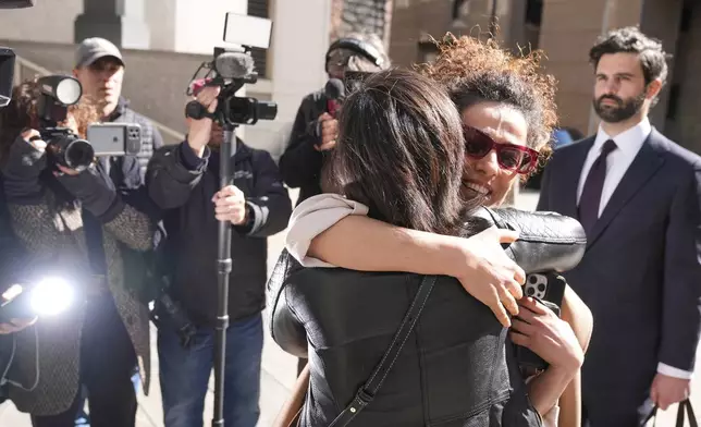 Masih Alinejad greets friends and supporters outside the federal courthouse after testifying at the trial of two men accused of allegedly plotting to kill her in New York, Tuesday, March 18, 2025. (AP Photo/Seth Wenig)