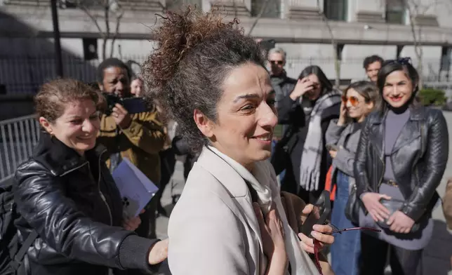 Masih Alinejad greets friends and supporters outside the federal courthouse after testifying at the trial of two men accused of allegedly plotting to kill her in New York, Tuesday, March 18, 2025. (AP Photo/Seth Wenig)