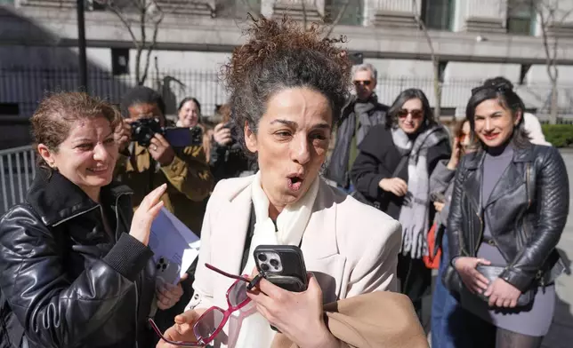 Masih Alinejad greets friends and supporters outside the federal courthouse after testifying at the trial of her would-be assassins in New York, Tuesday, March 18, 2025. (AP Photo/Seth Wenig)
