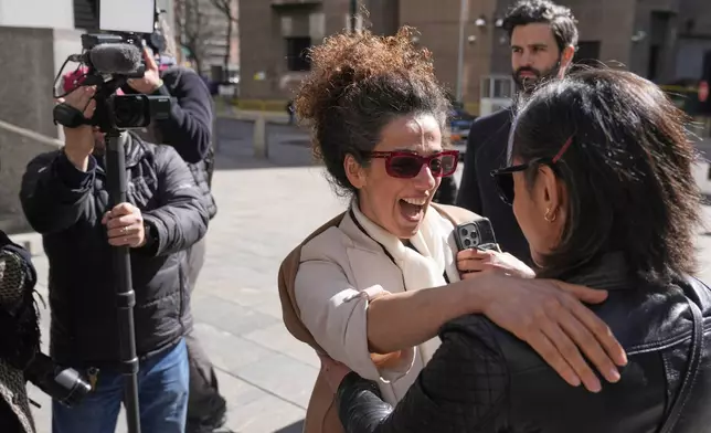 Masih Alinejad greets friends and supporters outside the federal courthouse after testifying at the trial of her alleged would-be assassins in New York, Tuesday, March 18, 2025. (AP Photo/Seth Wenig)
