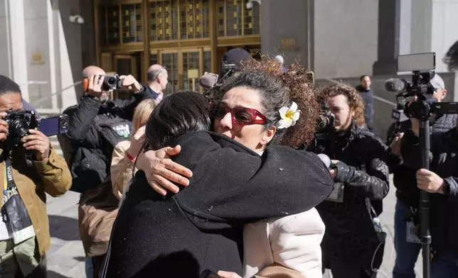 Masih Alinejad greets friends and supporters outside the federal courthouse after testifying at the trial of her would-be assassins in New York, Tuesday, March 18, 2025. (AP Photo/Seth Wenig)