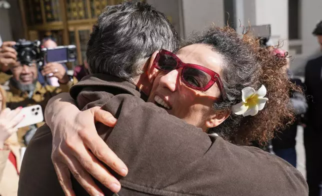 Masih Alinejad greets friends and supporters outside the federal courthouse after testifying at the trial of her would-be assassins in New York, Tuesday, March 18, 2025. (AP Photo/Seth Wenig)