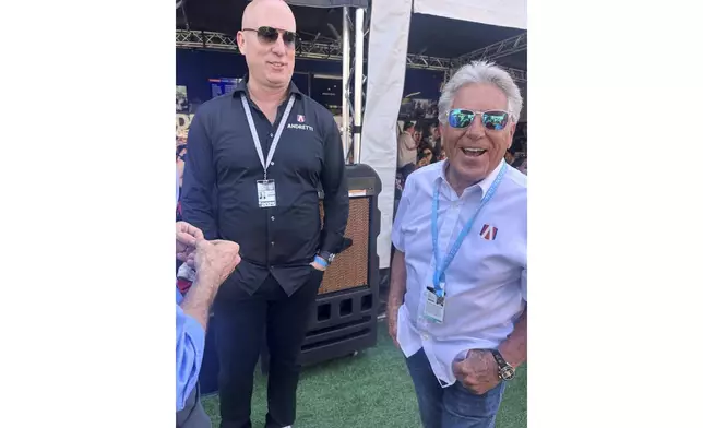 Dan Towriss, the new owner of Andretti Global, laughs with Mario Andretti before the IndyCar Series season-opening race, Sunday, March 2, 2025, in St. Petersburg, Fla. (AP Photo/Jenna Fryer)