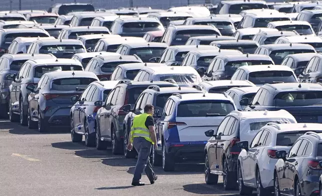 New German cars are stored at a logistic center in Duisburg, Germany, Thursday, March 27, 2025. (AP Photo/Martin Meissner)