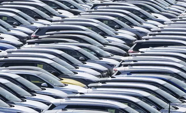 New German cars are stored at a logistic center in Duisburg, Germany, Thursday, March 27, 2025. (AP Photo/Martin Meissner)