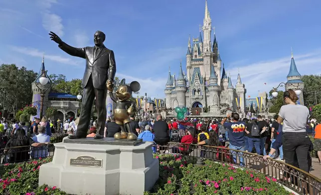 FILE - A statue of Walt Disney and Micky Mouse stands in front of the Cinderella Castle at the Magic Kingdom at Walt Disney World in Lake Buena Vista, Fla., Jan. 9, 2019. (AP Photo/John Raoux, File)