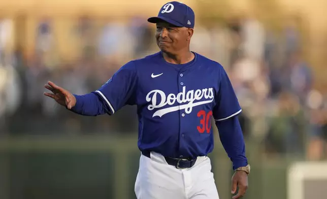Los Angeles Dodgers manager Dave Roberts walks to the dugout before a spring training baseball game against the Los Angeles Angels, Friday, Feb. 28, 2025, in Phoenix. (AP Photo/Ashley Landis)