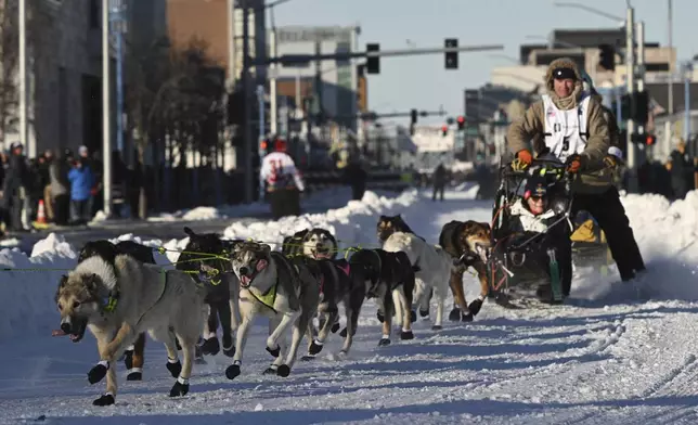 FILE - Mats Pettersson, from Sweden, makes the corner onto Cordova Street during the Iditarod Trail Sled Dog Race ceremonial start in Anchorage, Alaska, on Saturday, March 2, 2024. (Bob Hallinen/Anchorage Daily News via AP, File)