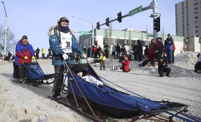 Charmayne Morrison (30), of Bozeman, Mont., turns the corner onto Cordova Street during the Ceremonial Start of the Iditarod Trail Sled Dog Race in Anchorage, Alaska., Saturday, March 1, 2025. (AP Photo/Amanda Loman)
