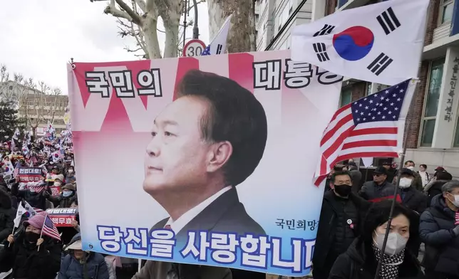 FILE - Supporters of impeached South Korean President Yoon Suk Yeol attend a rally to oppose his impeachment near the Constitutional Court in Seoul, South Korea, on Feb. 25, 2025. The letters read "The people's president." (AP Photo/Ahn Young-joon, File)
