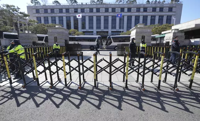 FILE - South Korean police officers stand guard in front of the Constitutional Court in Seoul, South Korea, on Feb. 18, 2025. (AP Photo/Lee Jin-man, File)