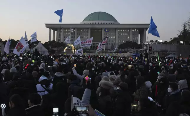 FILE - Participants react after hearing the news that South Korea's parliament voted to impeach President Yoon Suk Yeol outside the National Assembly in Seoul, South Korea, on Dec. 14, 2024. (AP Photo/Lee Jin-man, File)